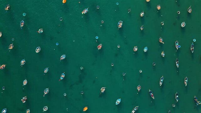 traditional fishing boats and round basket coracles scattered in turquoise clear sea water, creative gems and diamonds abstract pattern, Danang Vietnam, aerial top down drone view 4k