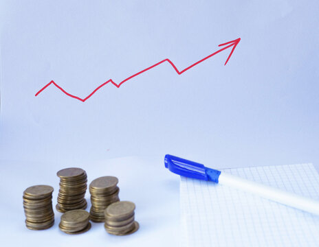 Stacks of coins with an upward trending graph drawn on white paper, representing financial growth, savings, investment and business success.


  Копіювати назву й опис