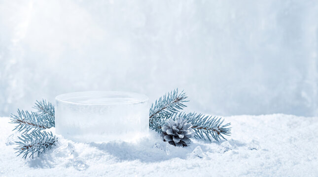 Snowy scene features a clear ice pedestal. Frosty pine branches and cones surround it. Soft, diffused light highlights the tranquil winter setting