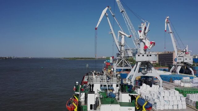 Cargo ship unloading containers at harbor