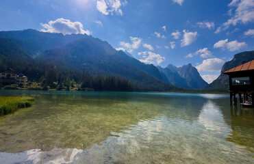 Fototapeta premium mountain in morning light reflected in calm waters of lake Dolomites Italy