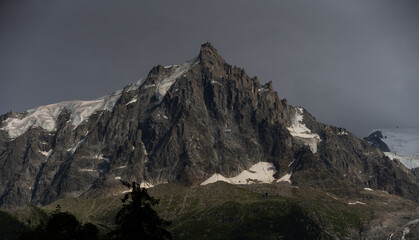 Fototapeta premium Summer view of the Mont Blanc massif above forested slopes 