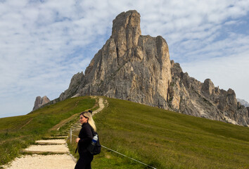 Fototapeta premium tourists walking in the dolomites at giau pass in summer italy