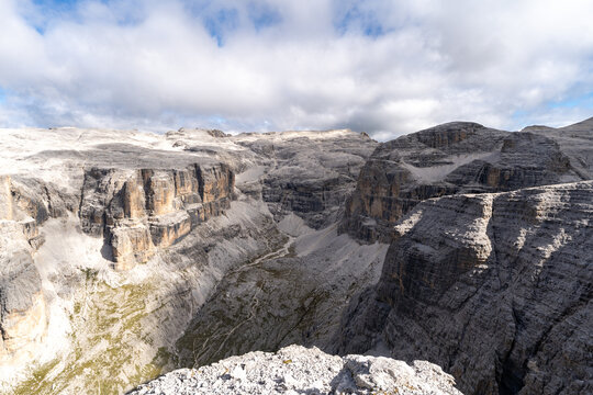 Rugged rocky cliffs and deep alpine canyon in the Dolomites, Italy