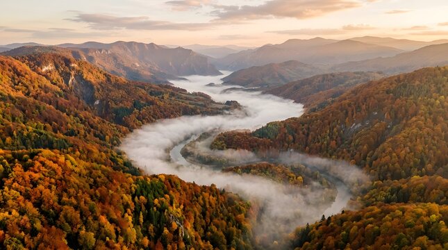 Autumnal river valley landscape with fog aerial view golden hour light