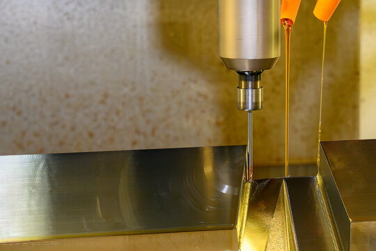 Surface finishing process of mold parts using a long ball nose end mill and oil coolant on a CNC milling machine