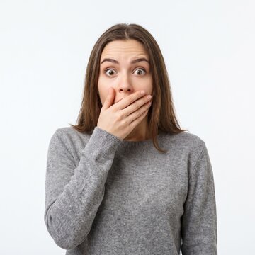 Surprised Young Woman Covering Her Mouth with Her Hand