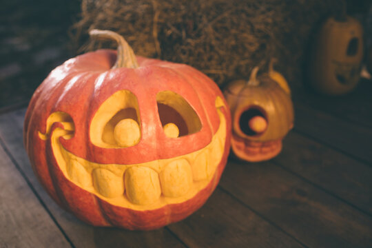 Ghost pumpkins on Halloween. ead Jack on an autumn background. Holiday outdoor decorations