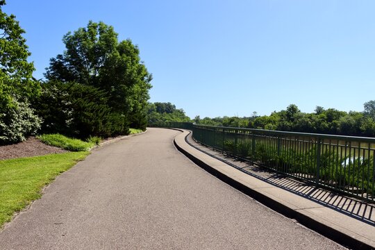 The long walkway in the park on a sunny day.
