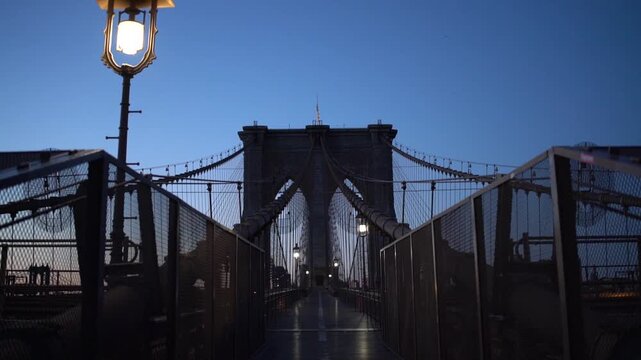 Morning pan across a Brooklyn Bridge tower and street lamp