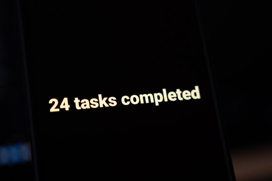 24 tasks completed in bold cream letters on a black smartphone screen, concept of high productivity, finished to do list, task management success, efficient work day and AI automation results