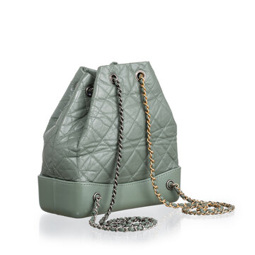 Green quilted lambskin backpack featuring a rigid base and mixed silver and gold metal chain shoulder straps