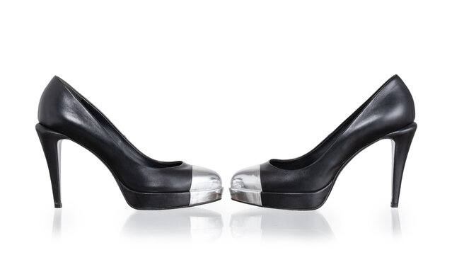 High-heeled pumps in black leather with a rigid silver cap_toe. Photographed on a white background.