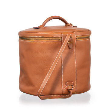 Brown leather cylindrical beauty case with gold hardware, lock, and clasp. Photographed against a white background.