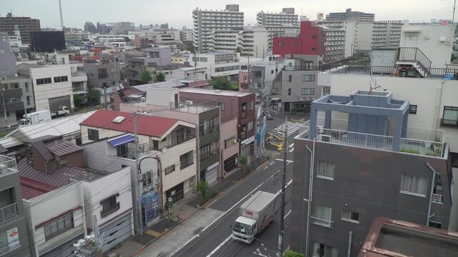 High angle view of Japanese residential area with narrow street power lines and modern apartment buildings in Tokyo