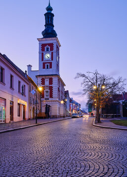 Town hall clock tower with Christmas lights at dusk in Slany