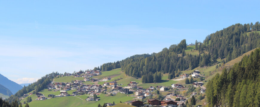 Houses Scattered Across Green Hills in Selva di Val Gardena