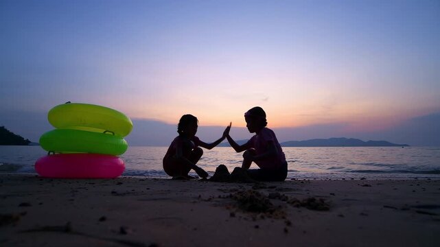 Children playing joyful at the beach during playful and enjoying funny of summer semester vacations .
