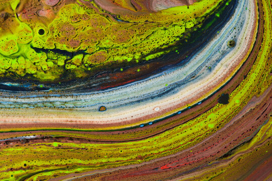 Unique liquid paint texture featuring bright neon green, yellow, brown, and blue marbled layers.