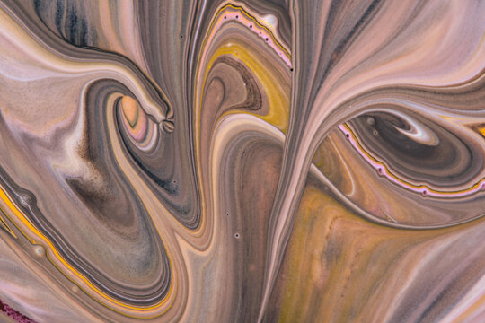 Abstract fluid paint marble background featuring beige, brown, grey, and soft pastel swirling patterns.
