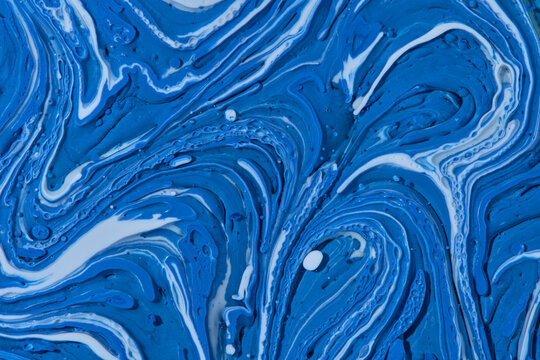 Dynamic 3D texture vibrant blue and white acrylic paint forming thick swirling paint ridges.