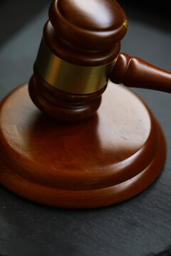 Gavel on Wooden Block Symbolizing Law and Justice in Courtroom Setting