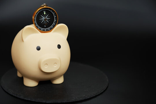 Piggy Bank with Compass: Navigating Personal Finance and Savings Direction