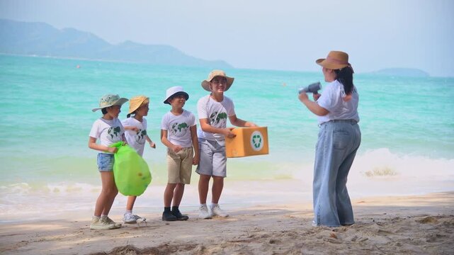Group of teacher and school children on ecotourist trip  learning show beach take care of environment.