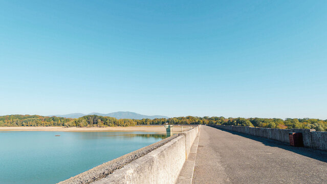  Lake Michelbach in Aspach-Michelbach community of the Haut-Rhin department. The main dike with a view of the lake's water intake tower. The dry northern shore bordering the Gruenewald forest