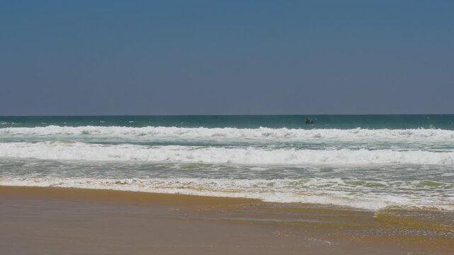 Slow motion waves breaking on an empty beach
