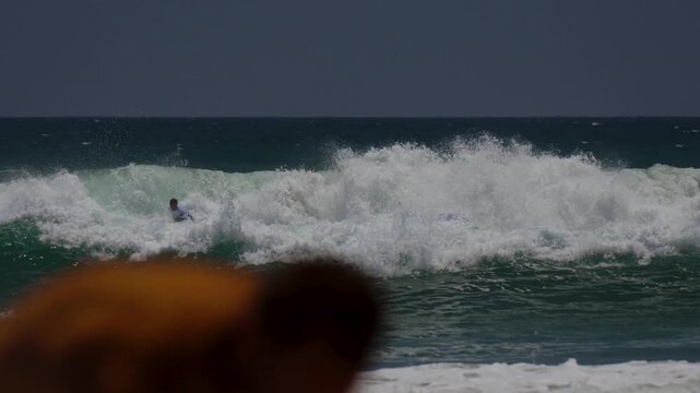surfer doing big turn on a white wave