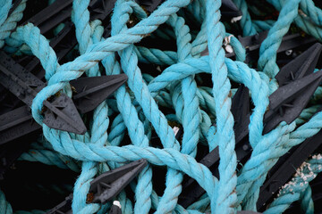 Turquoise rope knots and overlapping strands create a nautical texture on Lewis and Harris, Outer Hebrides, Scotland. © George