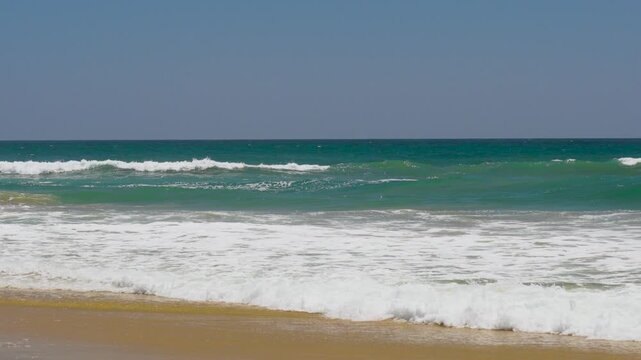 Waves breaking on the beach on a beautiful day