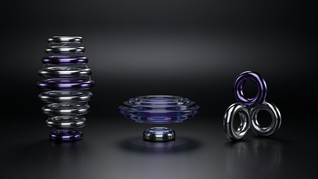 Three abstract metallic consisting of a stacked ring tower, a floating disc, and a cluster of three interlocking rings on a dark floor