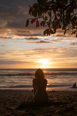 Silhouette of a woman sitting on the beach watching the sunset on the Nicoya Peninsula, Costa Rica © Julin