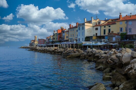 Colorful seaside town with Venetian architecture and a stone breakwater on the Adriatic coast