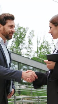Businessman and businesswoman meet, shake hands, and negotiate a business deal. Professional meeting, partnership, cooperation, communication, and business negotiation. Slow motion