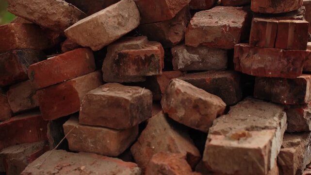 Stacked old red bricks in a pile outdoors