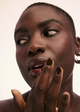 Person Touching Their Face With a Thoughtful Expression