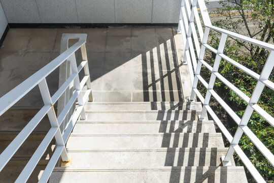 Concrete Outdoor Stairs and Railing with Strong Shadows