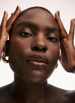Model Poses Facing the Camera With Hands on Her Head