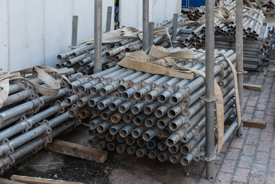Stacked steel scaffolding pipes and metal construction materials