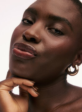 Woman Poses With Hand on Chin and a Confident Expression