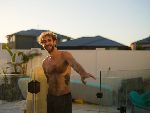Man holding a towel near a swimming pool
