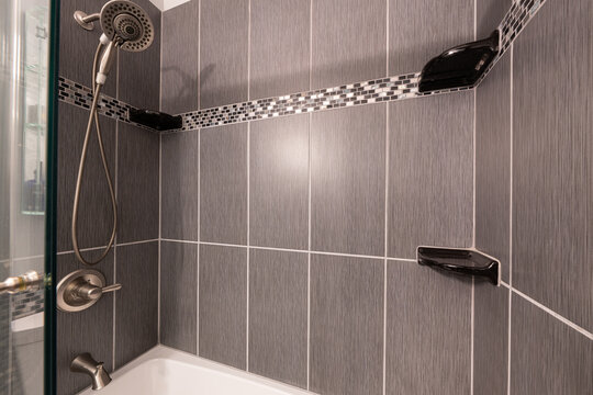 Bathroom shower has been updated with new ceramic tile and fixtures
