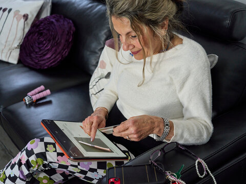 Senior Woman Shopping Online at Home Using an iPad