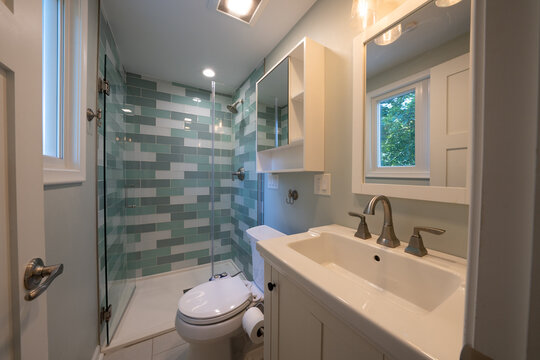 Bathroom shower has been updated with new ceramic tile and fixtures