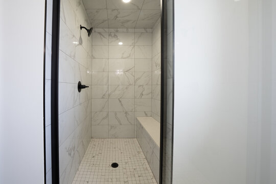 Bathroom shower has been updated with new ceramic tile and fixtures