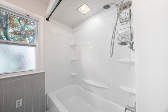 Bathroom shower has been updated with new ceramic tile and fixtures