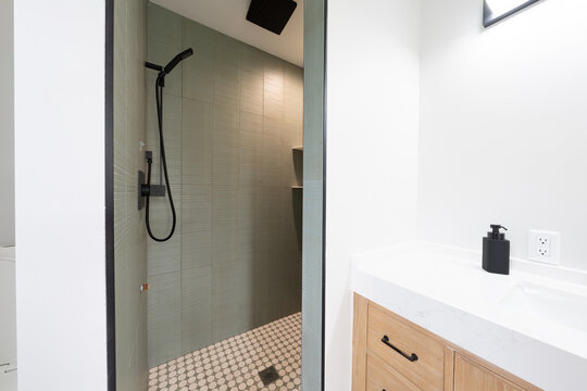 Bathroom shower has been updated with new ceramic tile and fixtures